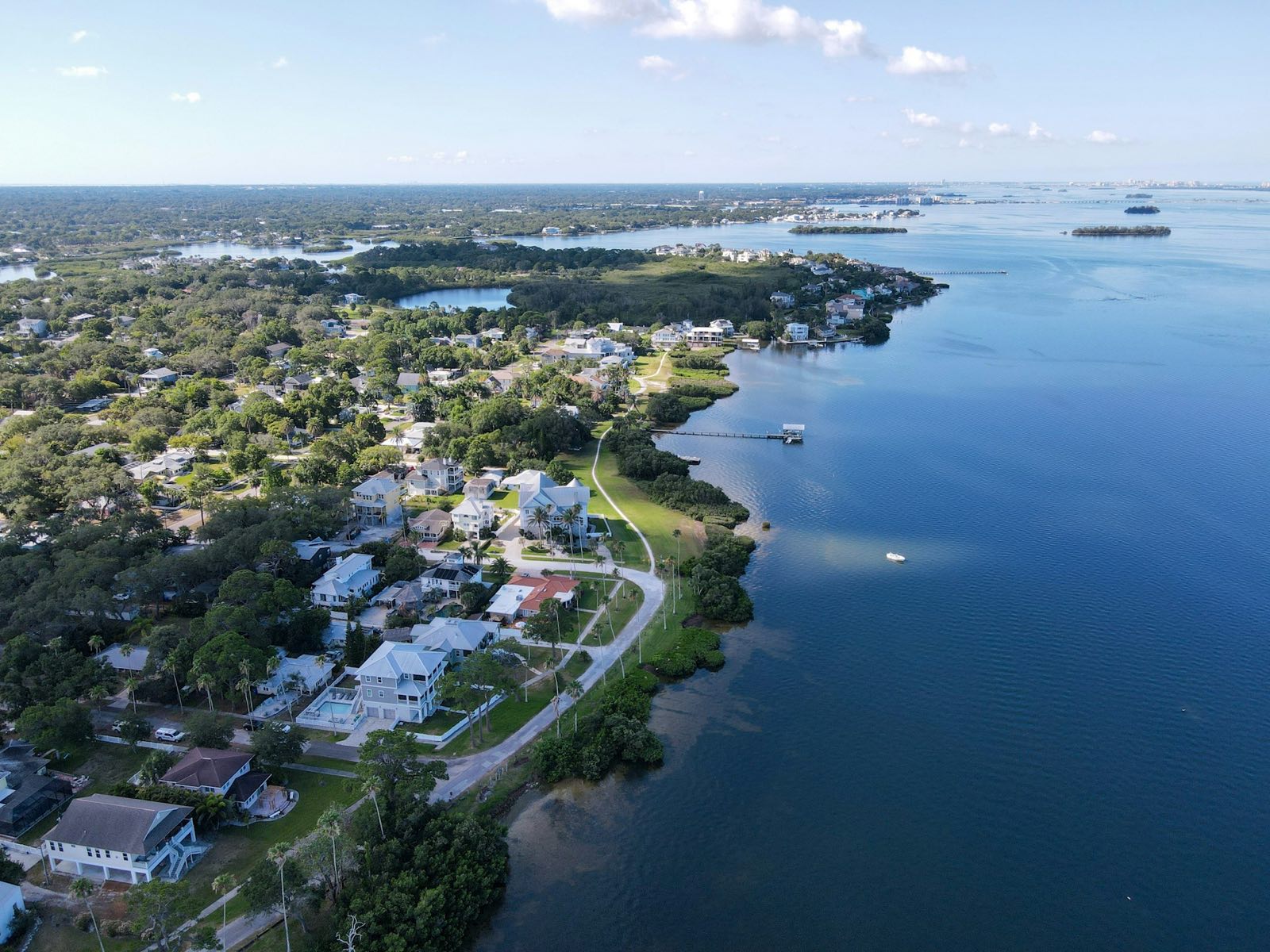 Aerial drone photography of a coastal Southwest Florida community threaded with canals and waterways.